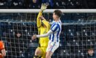 Dundee United keeper Jack Walton appears to be impeded by Kilmarnock attacker Marley Watkins