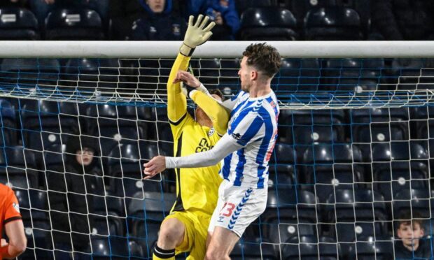 United keeper Jack Walton appears to be impeded by Kilmarnock attacker Marley Watkins. Image: SNS