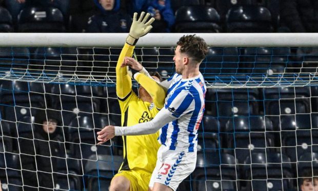 Dundee United keeper Jack Walton appears to be impeded by Kilmarnock attacker Marley Watkins