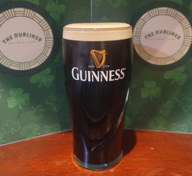 A pint of Guinness sits on a table at Dundee pub The Dubliner