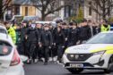 Police escorting a large group of young fans to Saturday's Fife derby. Image: Steve Brown/DC Thomson