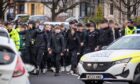 Police escorting a large group of young fans to Saturday's Fife derby. Image: Steve Brown/DC Thomson