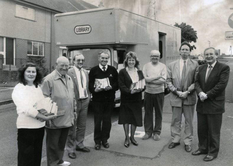 officials stand beside the new mobile library