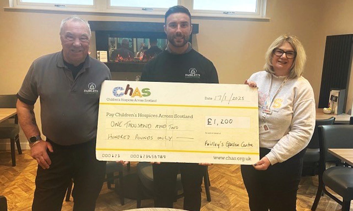 Chas community fundraiser Fiona Young accepts the latest cheque from George and Alexander McDonald. Image: Chas