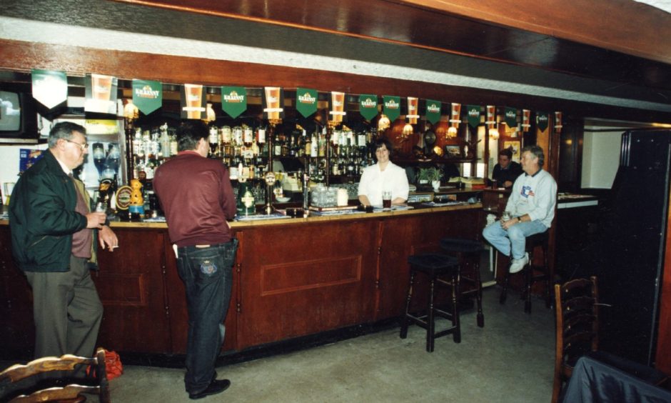 people sitting and standing at the bar in The Eagle Inn in October 1995.