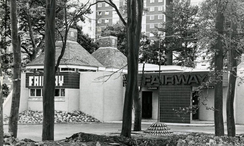 the exterior of The Fairway Bar in Ardler, Dundee, seen through trees