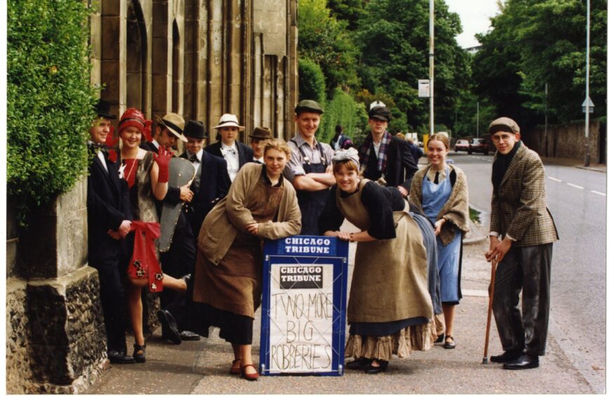 Harris Academy pupils in Perth Road with a Chicago Tribune billboard promoting their June 1994 musical production of Tin Pan Ali.