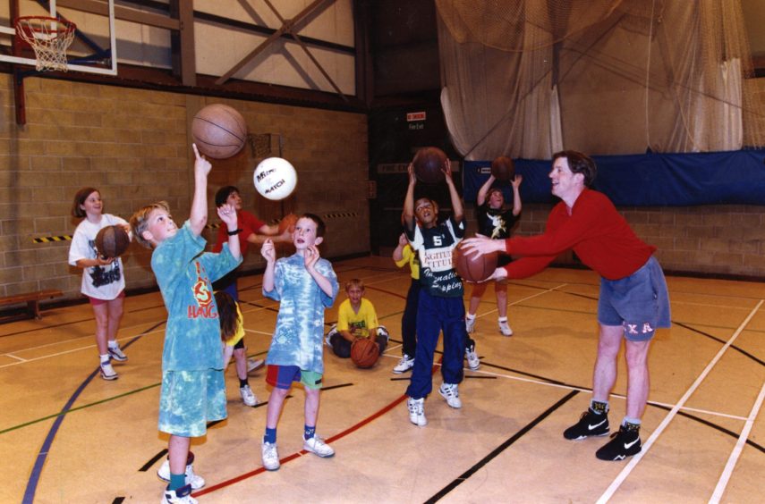 Children playing basketball at the holiday programme.