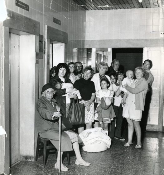 people queue for the lifts at Hoylake Court in Ardler in 1973. 