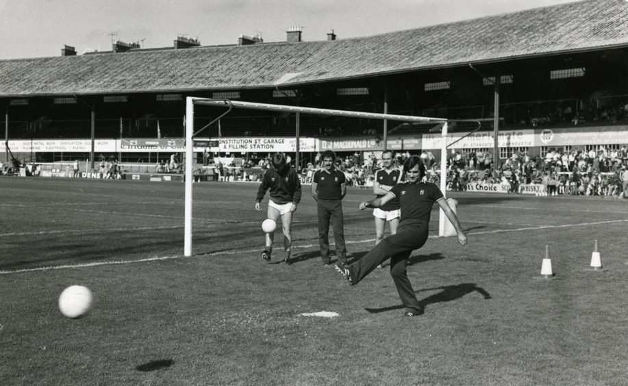 George Best shooting on the Dens Park pitch.