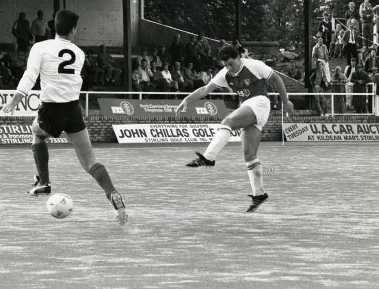 a defender tries to block the ball as Brian Kemp scores for Stirling Albion in 1987