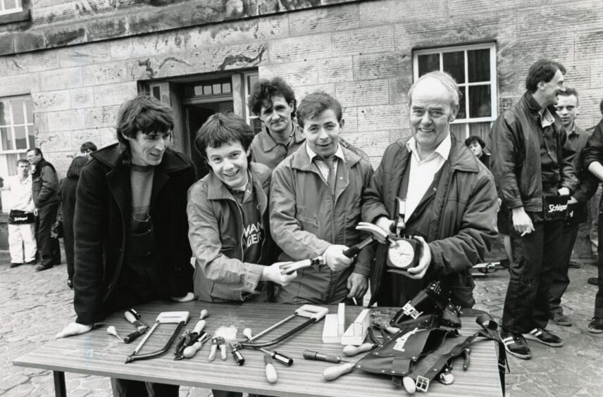 Competitors get to work at Stirling Castle at a table laden with tools