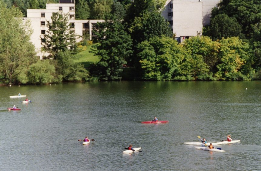 Several people in canoes in the loch at the University of Stirling in 1993.