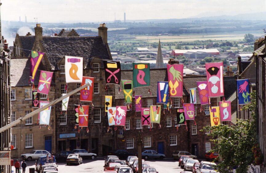 A range of colourful banners in Broad Street in Stirling, promoting a street fair in August 1993.