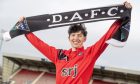 A smiling Owen Hampson is unveiled as a Dunfermline player at East End Park, holding a Dunfermline Athletic FC scarf above his head