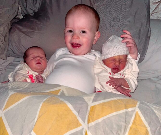 Fife twins in bed with brother Freddie