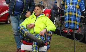 Rob Wainwright seated on chair at Blairgowrie Rugby Club