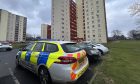 Police at the flats on Broomhead Drive in Dunfermline after the smoke bomb was set off. Image: Neil Henderson/DC Thomson