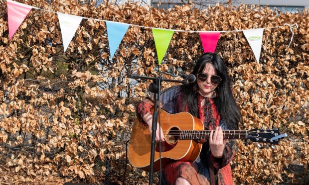 To go with story by Gemma Bibby. Local singer songwriter Nicola Madill performs as the first seeds are sown for the Eden Project?s first wildflower meadow in Dundee on Saturday. Credit - Chris Scott Photography Dundee. Picture shows; -. Dundee. Supplied by Chris Scott Photography Dundee Date; 26/03/2022