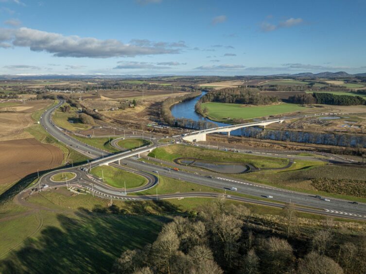 Drone view of A9 interchange, Destiny Bridge over River Tay and Cross Tay Link Road stretching through countryside to the east