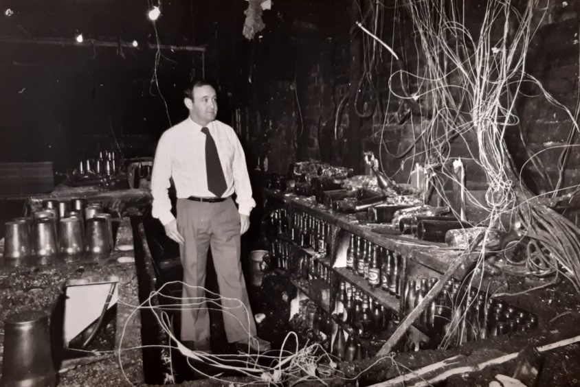 Jeff surveys the damage behind the bar after a fire gutted the Three Barrels