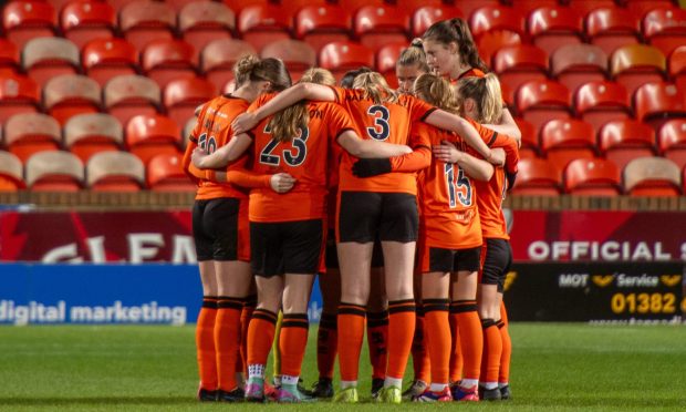 The Dundee United players in a huddle prior to the action commencing at Tannadice