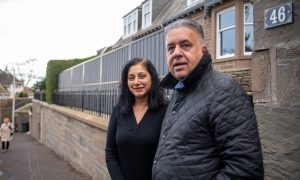 Santosh and Kirpal Chima with the fence outside their Farington Street home. Image: Kim Cessford/DC Thomson