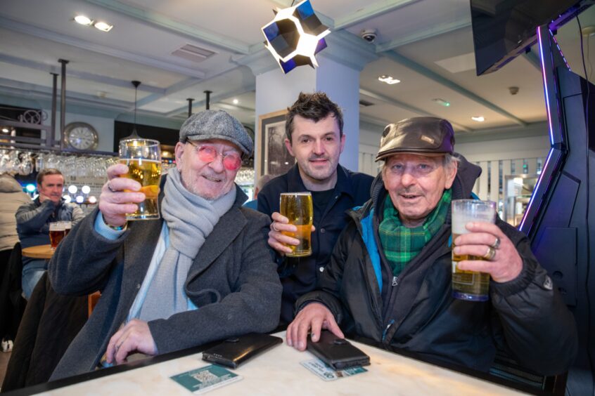 Gavin Archer, Kevin Green and Robert Flynn enjoy a pint in the Guildhall & Linen Exchange. 