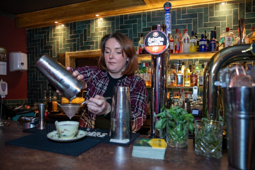 Haberdashery Bistro owner Chloe Wright mixes one of the pub's creative cocktails for Debbie.