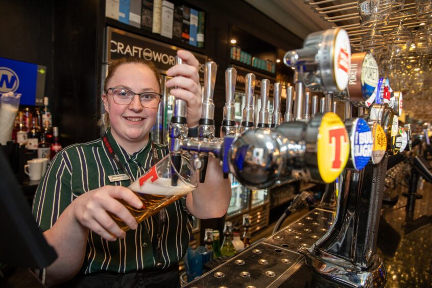 Jenny Cuthbert pours a pint in the Guildhall & Linen Exchange. 