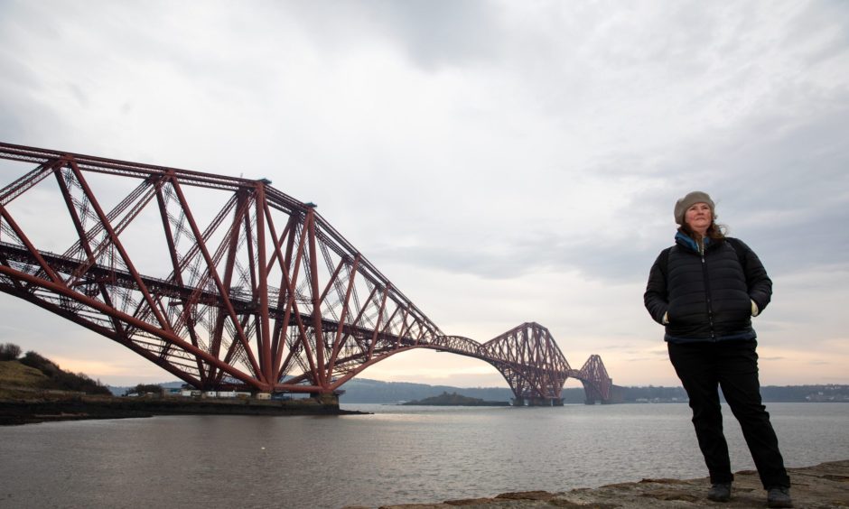 Image shows: feature writer Nora McElhone standing on the Town Pier at North Queensferry. The skies are grey and the Forth Bridge is in the background.