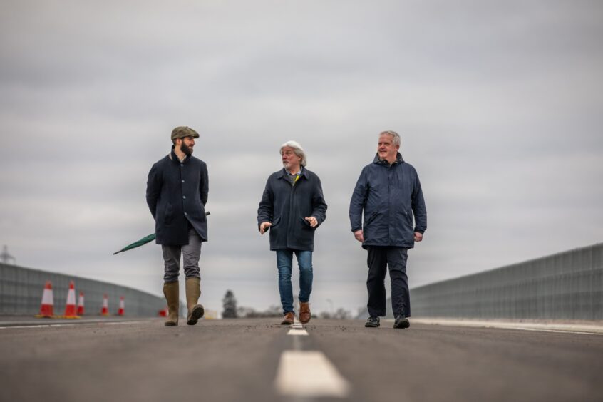 William Viscount Stormont, Grant Laing and Eric Drysdale walking across Destiny Bridge