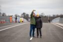 Couple wrapped up in anoraks posing for selfie on Destiny Bridge