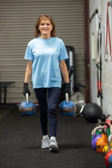 Eve working out with kettlebells.