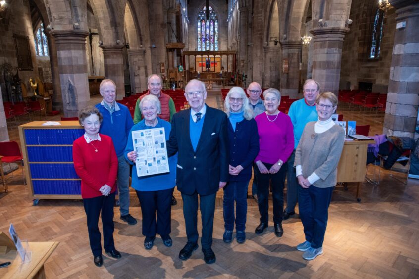 Minister Sandy Gunn and group of people standing inside St John's Kirk