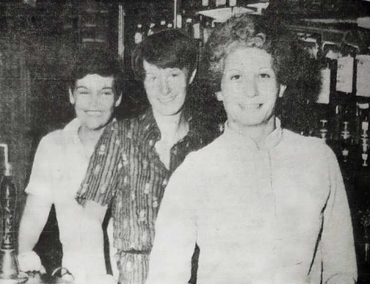 Staff members Wilma Gall, Sheila Stanton and Hazel Forbes pose for a picture behind the bar at The Three Barrels