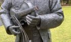 close up of statue with neck of fiddle snapped off