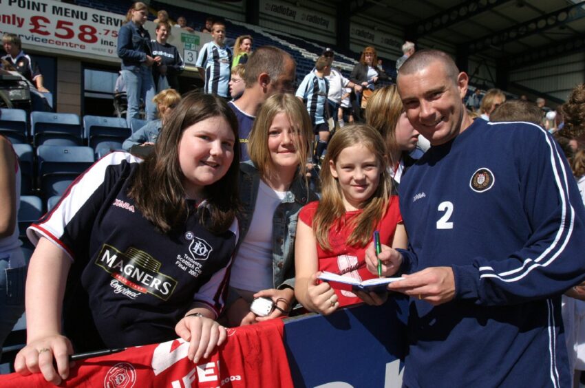 Barry Smith signs autographs for smiling young Dundee fans at a club open day