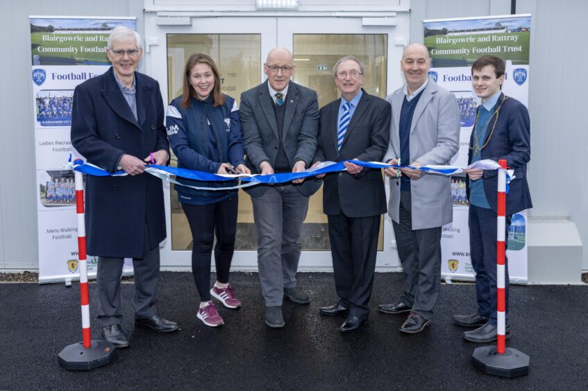 Group of people cutting blue ribbon to declare Blairgowrie and Rattray community pavilion open