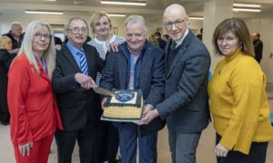 Group of people with celebration cake at opening of new Blairgowrie and Rattray community pavilion