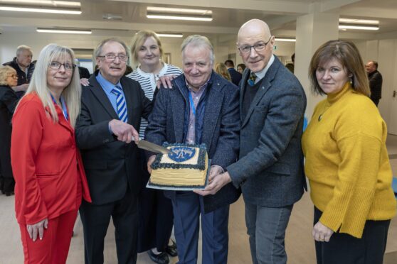 Group of people with celebration cake at opening of new Blairgowrie and Rattray community pavilion