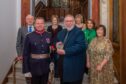 John Watson receiving award from Stephen Leckie watched by group of people in Perth Civic Hall