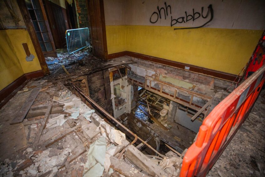 Drummond Arms interior, showing collapsed walls, floors and graffiti