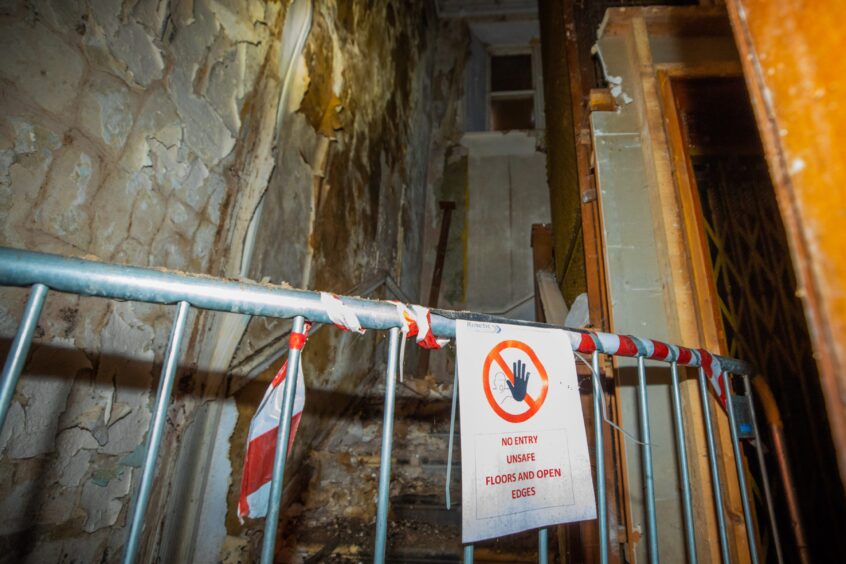 sign reading 'no entry, unsafe floors and open edges' inside Drummond Arms hotel