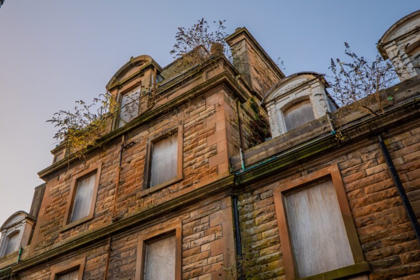 Weeds sprout from the roof of boarded-up Drummond Arms in Crieff