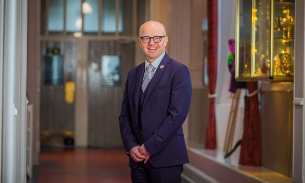 Rector Andrew McGarva in Morrisons Academy corridor.