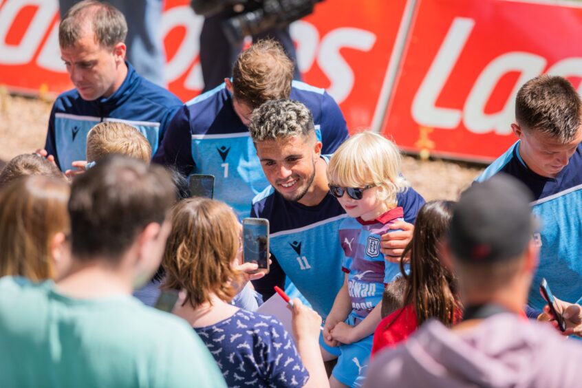 players pose for pictures with young fans at a Dundee FC open day 