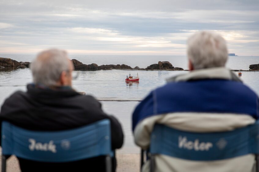 Image shows: brothers Alex and Charles Imrie sitting in their chairs at Cellardyke Tidal Pool.The chairs have Jack and Victor written on the back, inspired by the Still Game Characters.