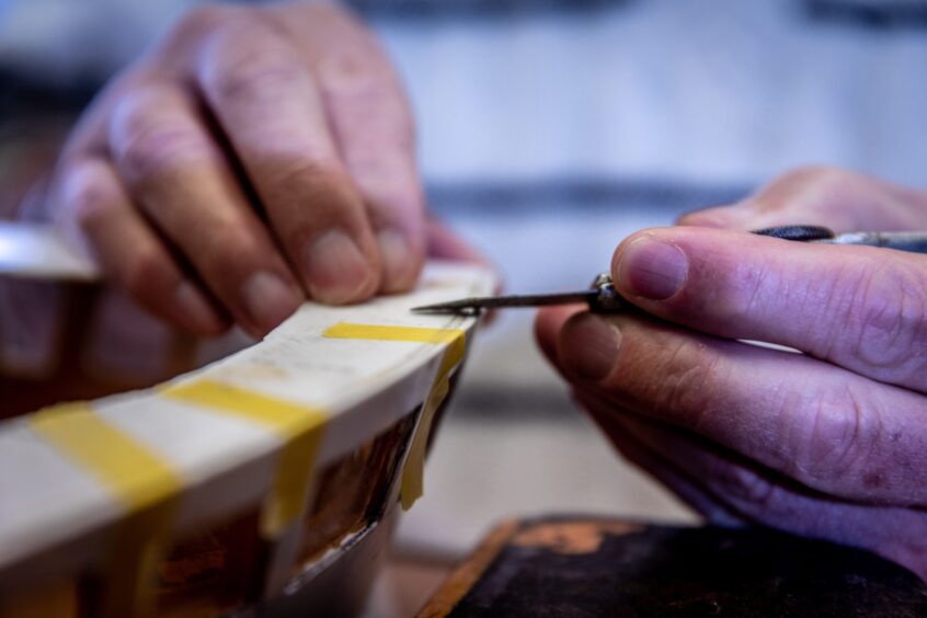 Image shows: Close up of detailed work on a model boat at The Scottish Fisheries Museum Model Boat Club.