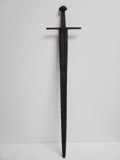 Very old looking sword against white background